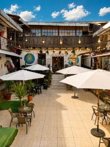 a patio with tables and umbrellas in a building at Terra House Hostel in Cusco
