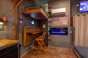 a room with a stove and an american flag on the wall at "Air Fort One" Aviation-Themed Luxury Treehouse Near Dollywood & Pigeon Forge in Sevierville