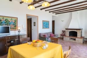 a living room with a table with a bowl of fruit on it at Cresta Panoramic apartments in Naso
