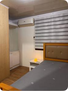 a small room with a bed and a window at Travellers Staycation in San Jose del Monte