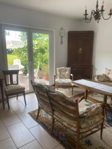 a living room with a table and chairs at Haus Else am Nationalpark Eifel in Schleiden