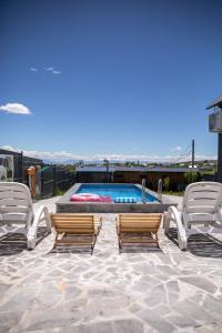a pair of chairs and a pool with a pair at AAA Byurakan Rest House in Ashtarak