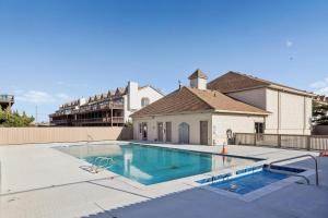 a swimming pool in front of a house at The Gallery in Kitty Hawk
