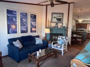 a living room with a blue couch and a table at The Gallery in Kitty Hawk