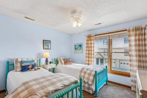 a bedroom with two beds and a window at The Gallery in Kitty Hawk +56 photos