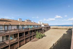 a row of balconies on a building with the ocean in the background at The Gallery in Kitty Hawk