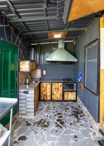 a kitchen with wooden cabinets and a stove at AAA Byurakan Rest House in Ashtarak