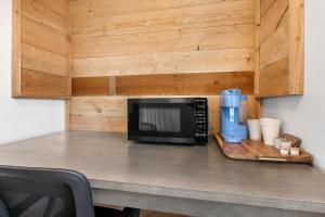 a counter with a microwave and a coffee maker on it at Copper Hill Suites in Butte