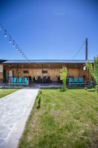 a pavilion with blue and white chairs in a park at AAA Byurakan Rest House in Ashtarak