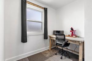 an office with a desk and a chair next to a window at Copper Hill Suites in Butte