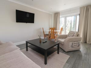 a living room with a couch and a coffee table at Beacon Fell Cottage 1 in Preston