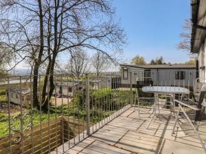 a patio with a table and a fence at Beacon Fell Cottage 1 in Preston