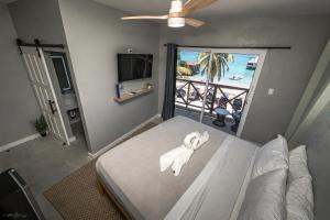 a bedroom with a bed and a view of the ocean at Sandbar Beachfront Hotel & Hostel Restaurant in San Pedro