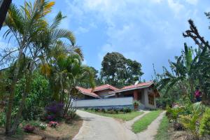 a house in the middle of a dirt road at Hillwoods homestay in Somvārpet