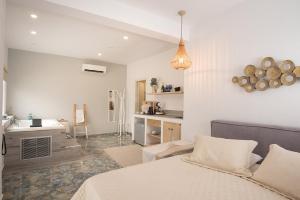a bedroom with a bed and a sink in it at Hyperion Hotel in Myrties +71 photos