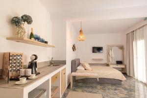 a bedroom with a bed and a counter with a sink at Hyperion Hotel in Myrties