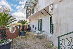 a patio with a table and a fence at La Casa Del Bosco - Two floors home in Naples