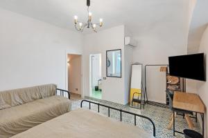a living room with a couch and a flat screen tv at La Casa Del Bosco - Two floors home in Naples