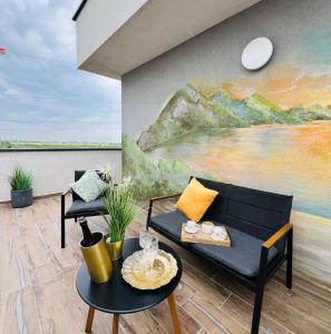a living room with a couch and a painting at Bridge Apartments in Timişoara