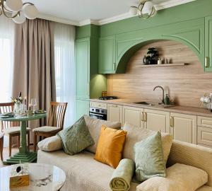 a living room with a couch and a kitchen at Bridge Apartments in Timişoara