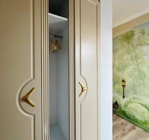 a door with gold handles in a hallway at Bridge Apartments in Timişoara +106 photos