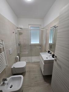 a bathroom with a toilet and a sink and a shower at Levante Land & Sea in Bari +1 photo