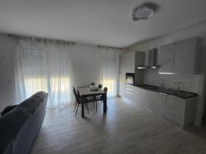 a living room with a table and a kitchen at Levante Land & Sea in Bari