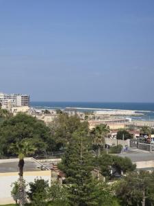 a view of a city with the ocean in the background at Levante Land & Sea in Bari