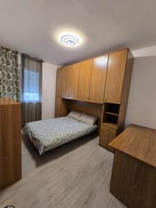 a bedroom with a bed and wooden cabinets at Levante Land & Sea in Bari