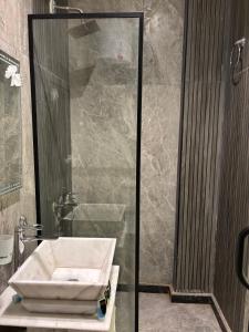 a bathroom with a sink and a shower at Hermes On The Spot Pyramids Hotel in Cairo +54 photos