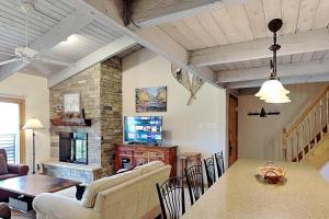a kitchen and living room with a table and a television at Timberline Condominiums 1 Bedroom plus Loft Deluxe Unit D3B in Snowmass Village