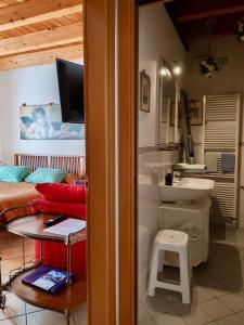 a bathroom with a bed and a sink in a room at Bed & Breakfast Lucy in Bardolino
