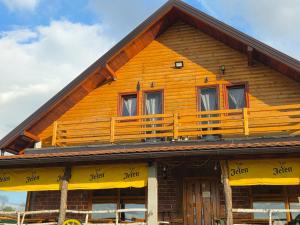 a wooden house with a balcony on top of it at Konoba Taline Sokolac in Rešetnica +15 photos