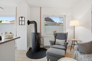 a living room with a wood stove and a chair at Kiek In in Greetsiel