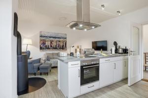 a kitchen with a sink and a stove at Kiek In in Greetsiel
