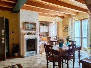 a kitchen and dining room with a table and a fireplace at Bed & Breakfast Lucy in Bardolino