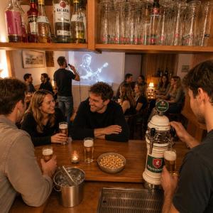a group of people sitting at a bar drinking beer at Alpinchalet Zigjam in Gaschurn