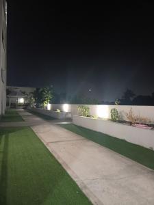 a fence with lights on it at night at Kingston Condo with Rooftop Pool & Gazebo in Kingston