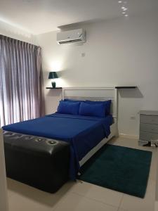 a bedroom with a bed with a blue comforter and blue pillows at Kingston Condo with Rooftop Pool & Gazebo in Kingston +29 photos