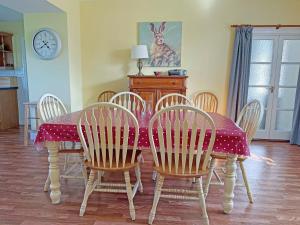 a dining room table and chairs with a red and white table cloth at Thelma's House - Uk48886 in Belford