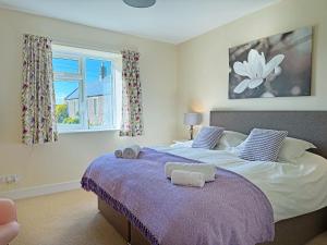 a bedroom with a large bed with towels on it at The Martin's - Uk48870 in Belford