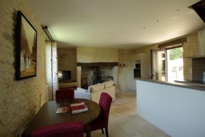a living room with a table and a couch at gîtes du Cheylard in Les Farges