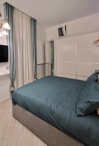 a bedroom with a bed with a blue comforter at Marè Sunrise in Bari