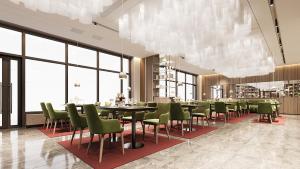 a restaurant with green chairs and tables and windows at NOMAD Luxe Hotel in Zharkent