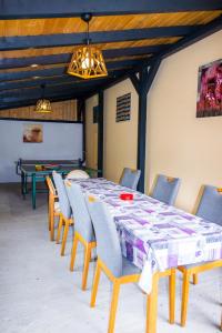a conference room with a table and chairs and a board at Cabana La Cucu in Vadu Moţilor