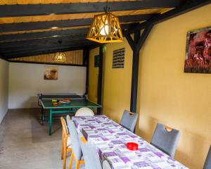 a dining room with a ping pong table and a ping pong table at Cabana La Cucu in Vadu Moţilor +19 photos
