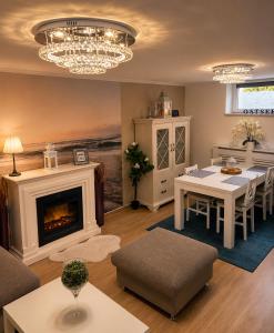 ein Wohnzimmer mit einem Tisch und einem Kamin in der Unterkunft Ferienwohnung Lakeside in Heiligenhafen