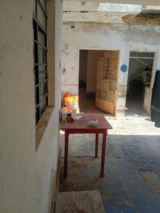 a small table in an old building with a room at Casona Morin in Piura