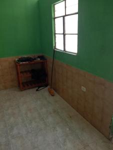 a room with a broom in the corner of a green wall at Casona Morin in Piura