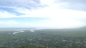 an aerial view of a city and a body of water at House near the mountains in Karakol